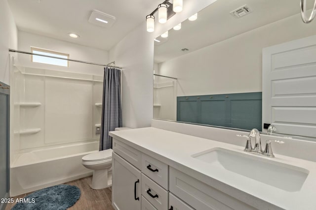 full bathroom featuring shower / bath combination with curtain, vanity, hardwood / wood-style flooring, and toilet