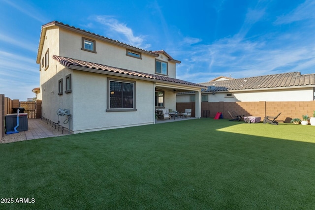 back of property featuring a patio area and a yard