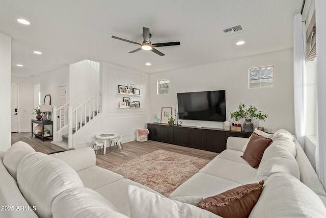 living room with ceiling fan and hardwood / wood-style flooring