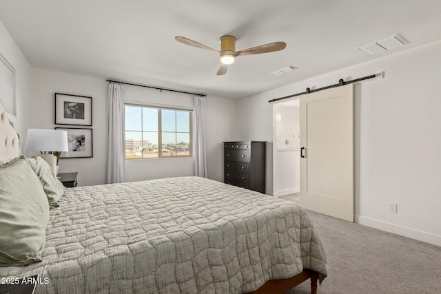 bedroom featuring carpet flooring, ceiling fan, and a barn door