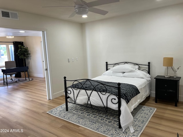 bedroom featuring light wood-style floors and baseboards