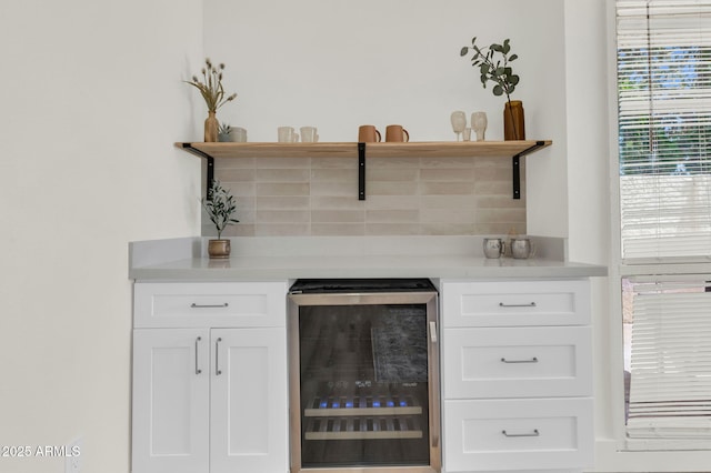 bar with beverage cooler and decorative backsplash