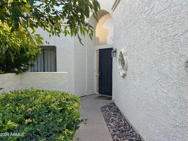 property entrance with stucco siding
