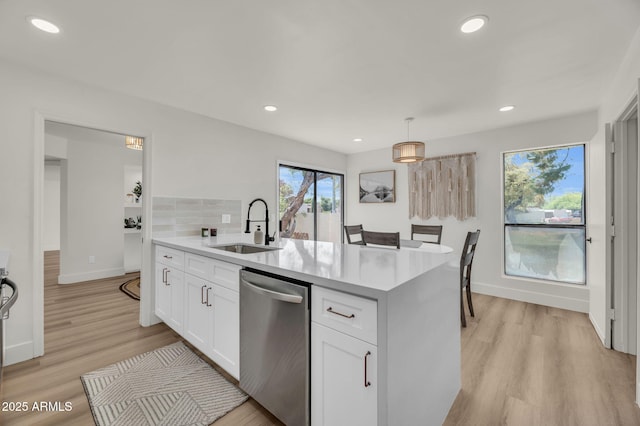 kitchen with stainless steel dishwasher, a sink, light wood finished floors, white cabinetry, and recessed lighting