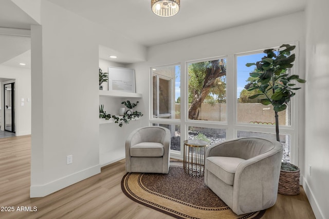 sitting room with wood finished floors, baseboards, and recessed lighting