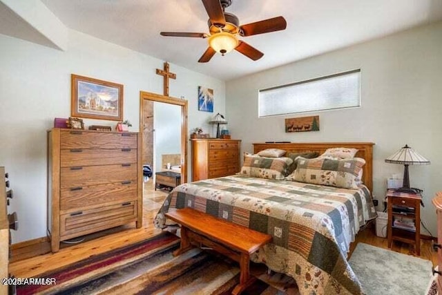 bedroom with hardwood / wood-style floors and ceiling fan