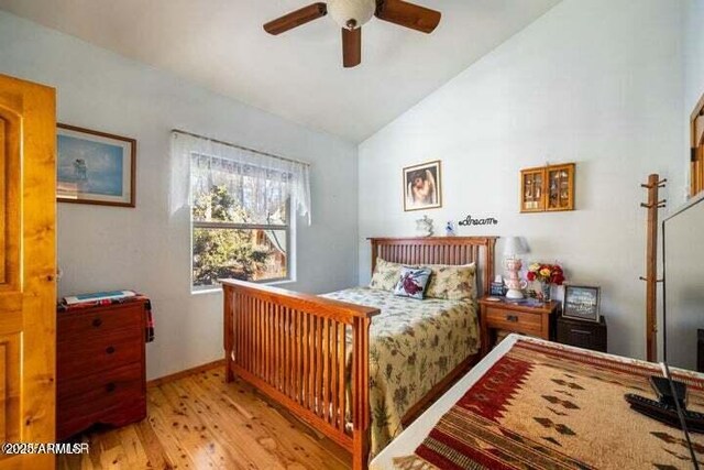 bedroom featuring lofted ceiling, light wood-type flooring, and ceiling fan