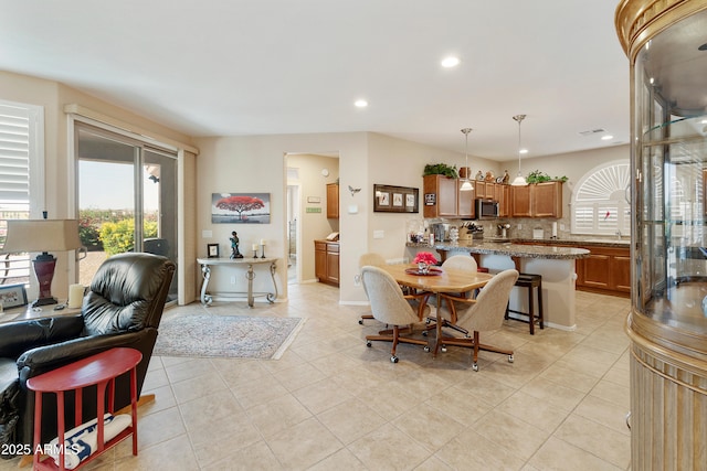 4245 E Ficus Way, Gilbert, AZ 85298 - dining room featuring healthy amount of natural light, recessed lighting, light tile patterned flooring, and baseboards