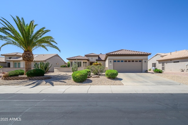 15134 W Waterford Dr, Surprise, AZ 85374 - mediterranean / spanish-style house with a garage, driveway, a tiled roof, and stucco siding
