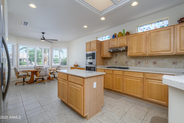 15134 W Waterford Dr, Surprise, AZ 85374 - kitchen with light tile patterned floors, light countertops, under cabinet range hood, visible vents, and stainless steel appliances