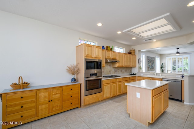 15134 W Waterford Dr, Surprise, AZ 85374 - kitchen with light countertops, a peninsula, recessed lighting, stainless steel appliances, and decorative backsplash