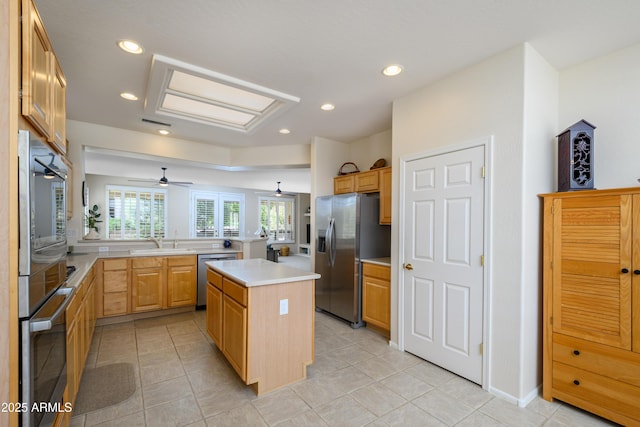 15134 W Waterford Dr, Surprise, AZ 85374 - kitchen featuring recessed lighting, a kitchen island, appliances with stainless steel finishes, a sink, and light countertops
