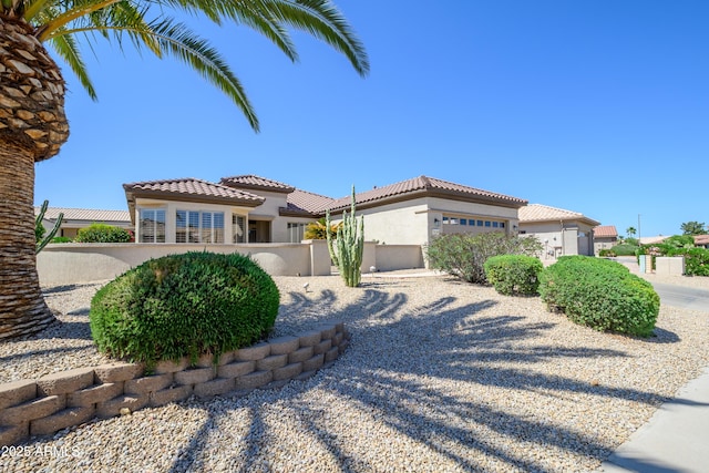 15134 W Waterford Dr, Surprise, AZ 85374 - mediterranean / spanish-style house with a tiled roof, fence, and stucco siding