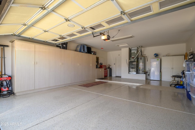 15134 W Waterford Dr, Surprise, AZ 85374 - garage with freestanding refrigerator, gas water heater, and a garage door opener