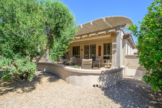 15134 W Waterford Dr, Surprise, AZ 85374 - back of property with a pergola, a patio, stucco siding, and fence