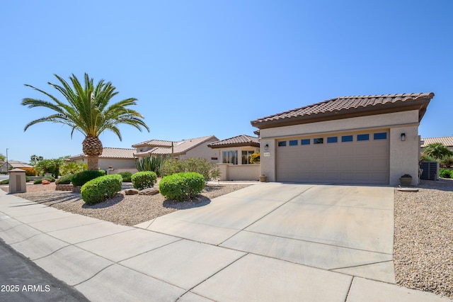 15134 W Waterford Dr, Surprise, AZ 85374 - view of front facade featuring stucco siding, driveway, an attached garage, central AC, and a tiled roof