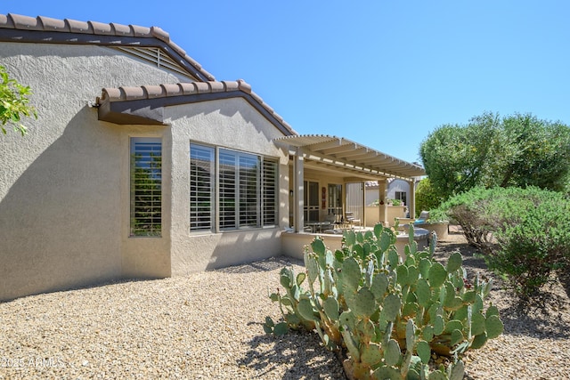 15134 W Waterford Dr, Surprise, AZ 85374 - rear view of property featuring a patio, a pergola, stucco siding, and a tile roof