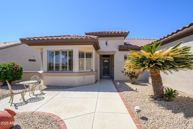 15134 W Waterford Dr, Surprise, AZ 85374 - mediterranean / spanish-style house featuring a tiled roof, a patio area, and stucco siding