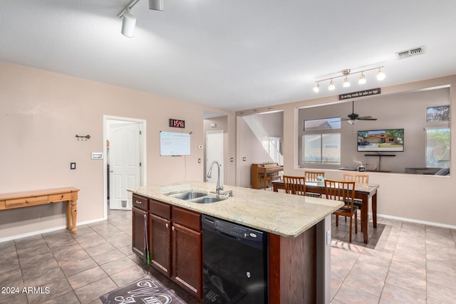 kitchen with sink, light tile patterned floors, black dishwasher, light stone countertops, and an island with sink