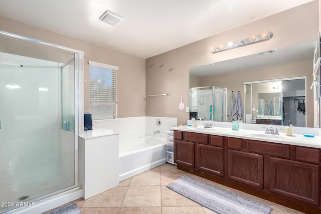 bathroom with vanity, tile patterned floors, and plus walk in shower