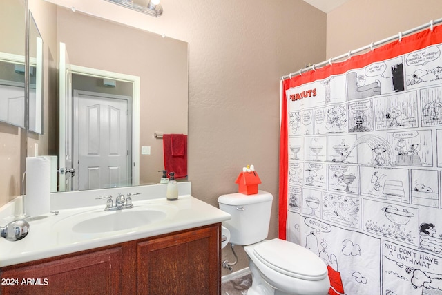 bathroom featuring vanity, toilet, and a shower with shower curtain