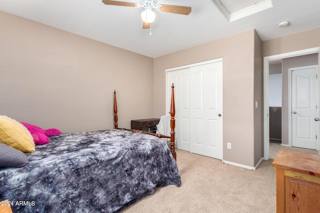 carpeted bedroom with ceiling fan and a closet