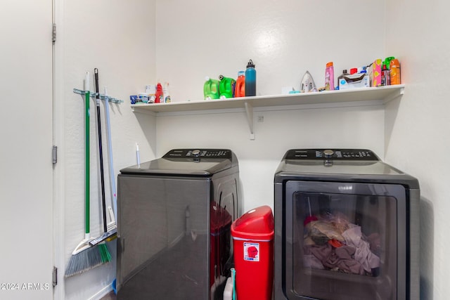 clothes washing area with washing machine and clothes dryer