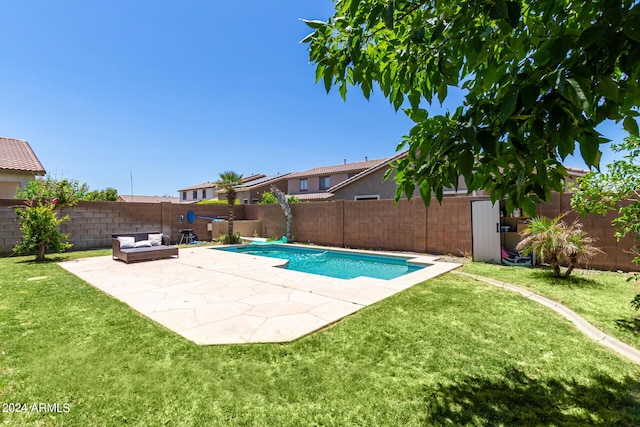 view of swimming pool with a yard and a patio area