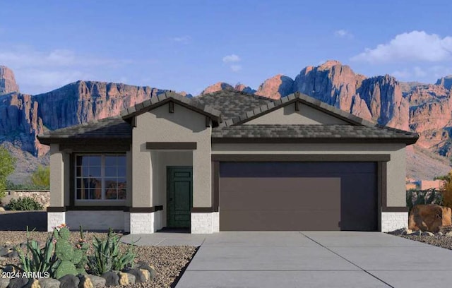 view of front of home with a mountain view and a garage