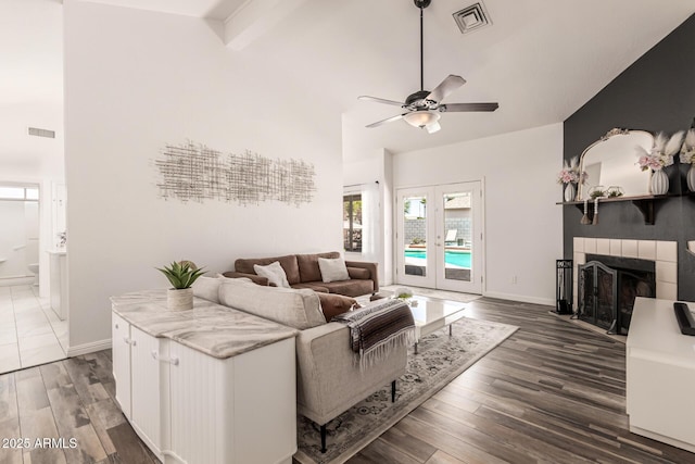 6156 W Del Rio St, Chandler, AZ 85226 - living area with high vaulted ceiling, a ceiling fan, dark wood-style flooring, a fireplace, and beam ceiling