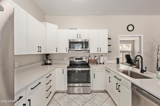 1500 N Sunview Pkwy Unit 81, Gilbert, AZ 85234 - kitchen featuring appliances with stainless steel finishes, open shelves, light countertops, and white cabinetry