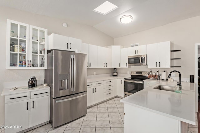 1500 N Sunview Pkwy Unit 81, Gilbert, AZ 85234 - kitchen featuring appliances with stainless steel finishes, light marble finish flooring, vaulted ceiling, a peninsula, and light countertops