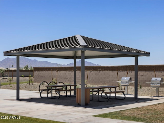 surrounding community featuring a mountain view, a gazebo, and a patio