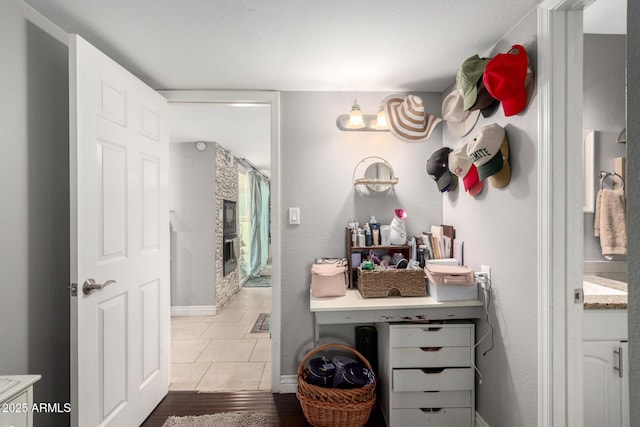 full bathroom with a shower, vanity, baseboards, and wood finished floors
