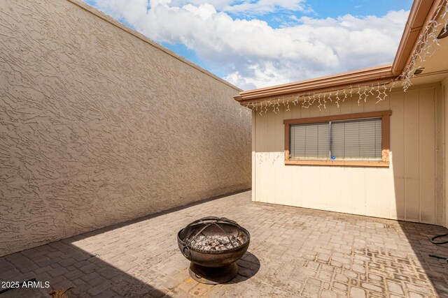 view of patio / terrace with an outdoor fire pit