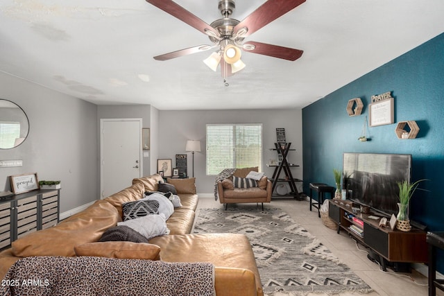 living room featuring light tile patterned flooring, baseboards, and a ceiling fan
