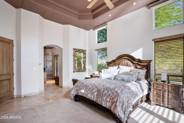 bedroom featuring ceiling fan and a high ceiling