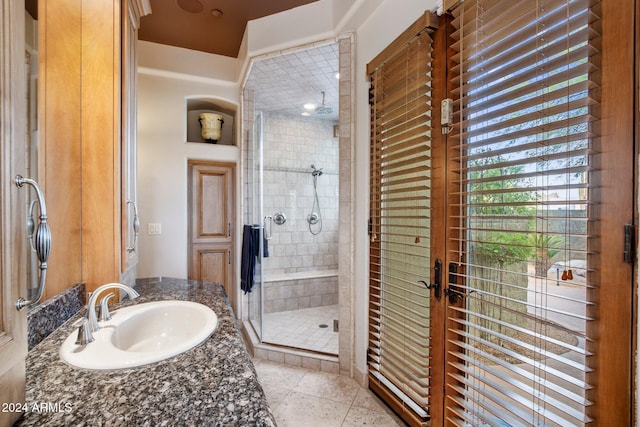 bathroom with tile patterned floors, vanity, and a shower with shower door