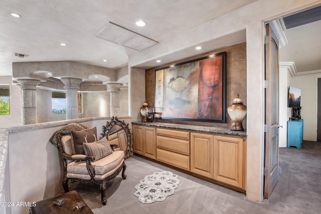 living area with light carpet and ornamental molding