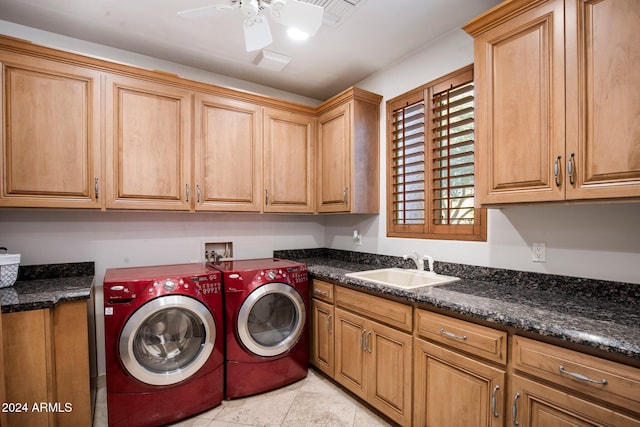 clothes washing area with cabinets, sink, ceiling fan, light tile patterned flooring, and washing machine and clothes dryer