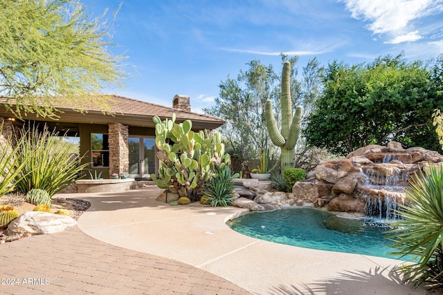 view of pool with a patio area and pool water feature