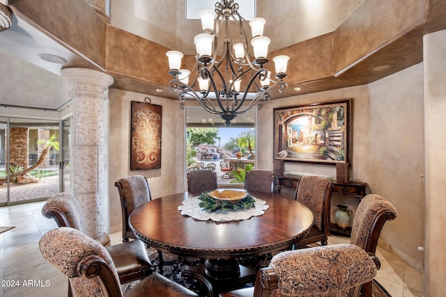 dining area with ornate columns, a high ceiling, and an inviting chandelier