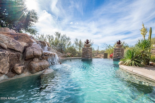 view of swimming pool with pool water feature