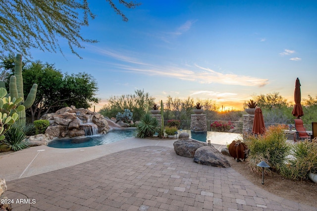 patio terrace at dusk with pool water feature