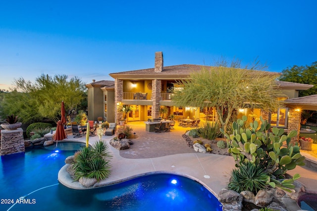 pool at dusk featuring a patio