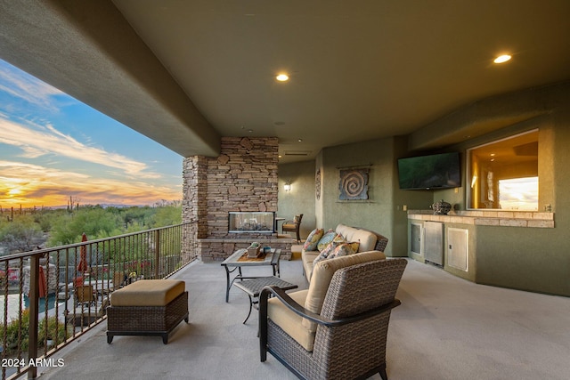 view of patio with an outdoor living space, a balcony, and wine cooler