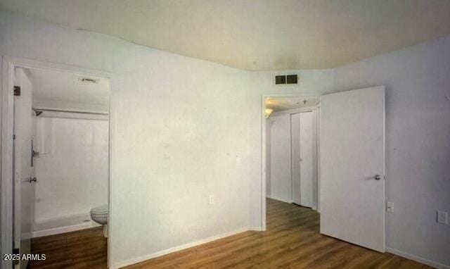 12221 W Bell Rd Unit 249, Surprise, AZ 85378 - unfurnished bedroom featuring wood finished floors and baseboards