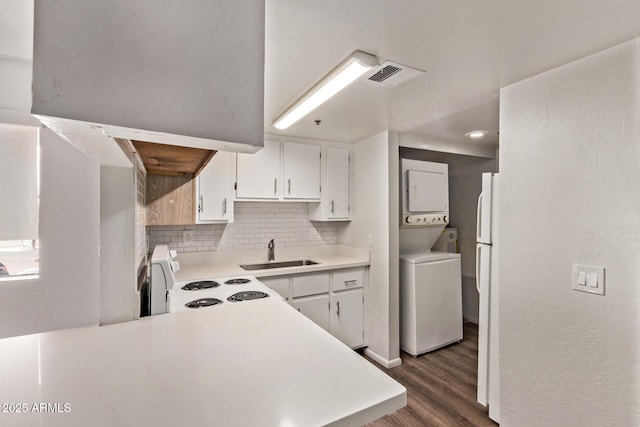 12221 W Bell Rd Unit 249, Surprise, AZ 85378 - kitchen with estacked washer and dryer, a sink, white range with electric stovetop, dark wood-style floors, and light countertops