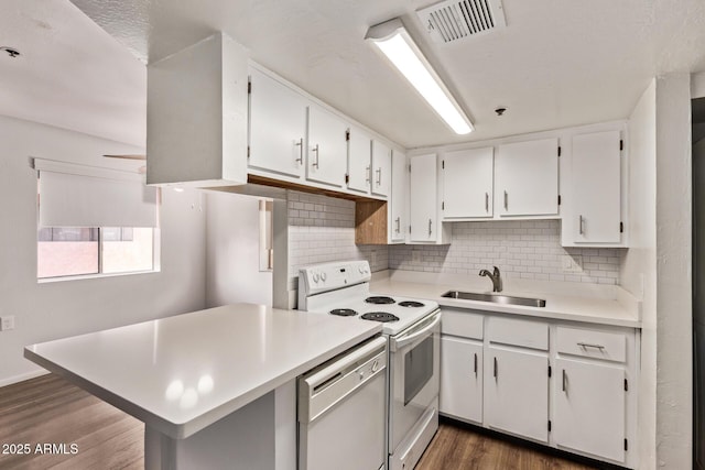 12221 W Bell Rd Unit 249, Surprise, AZ 85378 - kitchen featuring a sink, dishwasher, white electric stove, dark wood-type flooring, and tasteful backsplash