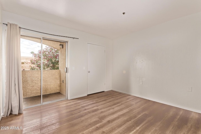 12221 W Bell Rd Unit 249, Surprise, AZ 85378 - empty room with light wood-type flooring and baseboards